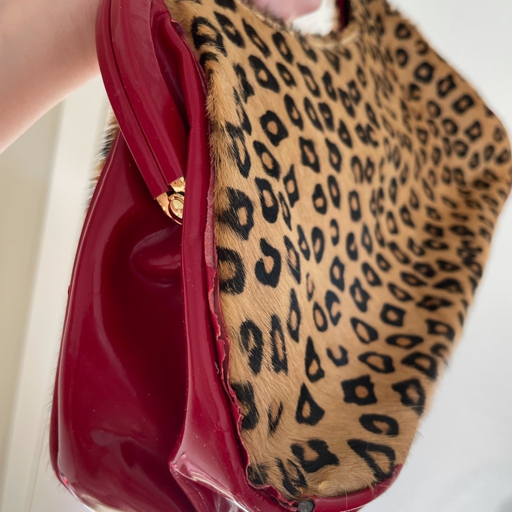 Beverly Feldman leopard print with red clutch bag